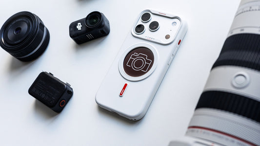 White XTREM instant custom phone case featuring a camera icon design placed with photography gear including lenses and action cameras.